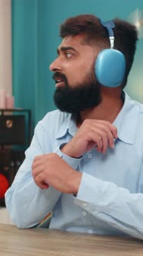 Man with Headphones Talking Indoors
