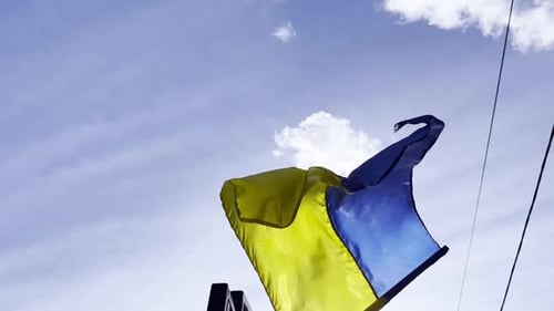 Ukraine Flag Waving Against Blue Sky