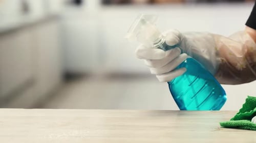 Cleaning Service Close Up of Woman Cleaning Table at Home with Spray Homework Clean of Ditry Kitchen
