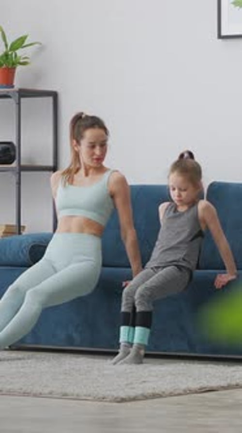 Woman and Girl Doing Exercises Together at Home