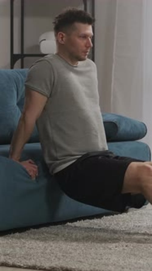 Athletic Man Doing Dips on Couch for Exercise