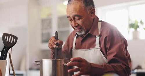 Senior Man Cooking Food in Bright Kitchen