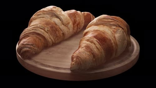 Rotating 3D Croissant Animation on Wooden Board