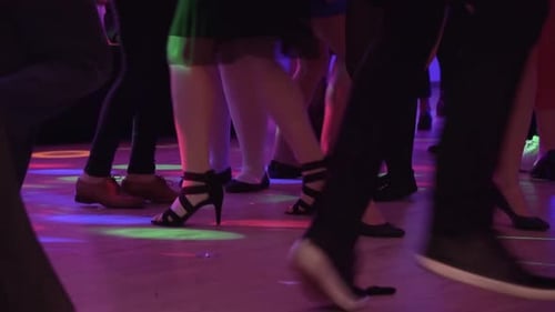 Legs of people dancing at the party