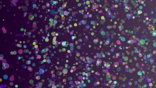 Partícula colorida brillante que cae sobre fondo negro, partícula bokeh que flota en la pantalla