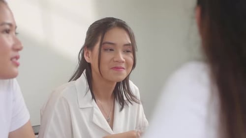 Three Young Women Chatting Indoors