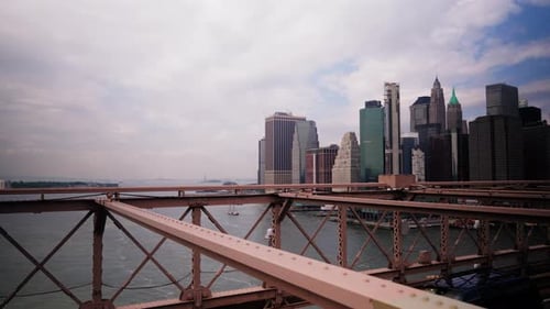 Cars Driving Along the Brooklyn Bridge Against Manhattan Skyline on Background