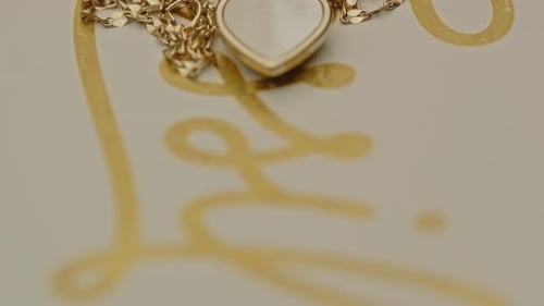 tilt up to a beautiful golden necklace with a small diamond in the pendant