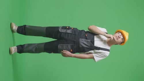 Full Body Of Worker Wearing Safety Helmet Thinking Then Raising His Index Finger On Green Screen