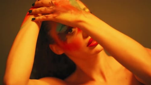 Beauty, paint and face of woman in neon lights in studio isolated on a background
