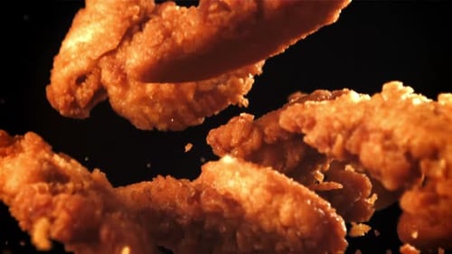 Crispy Fried Chicken Tenders on Black Background