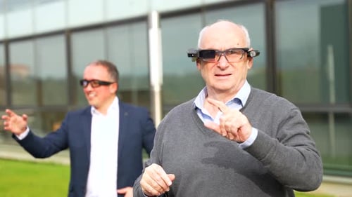 Senior Man Using Futuristic Wearable Technology Outdoors
