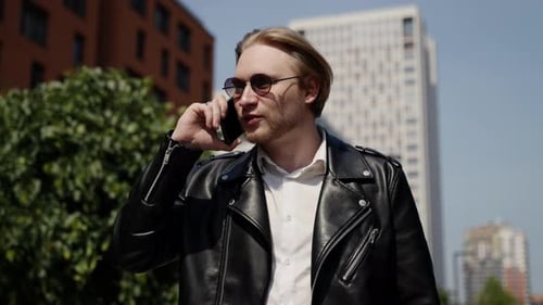 Man Talking on Phone in City Street