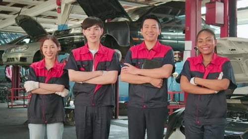 Portrait of multiracial professional mechanic team at the car service garage.