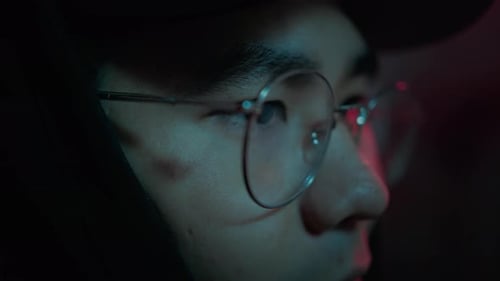 Close Up of Asian Hacker Looking on Screen of Computers