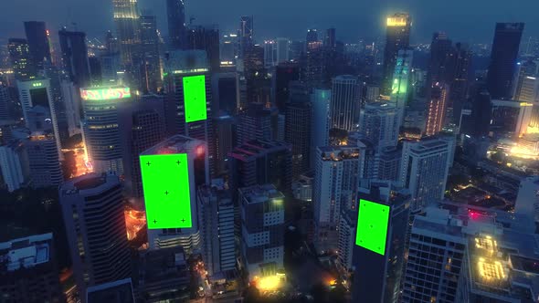 AERIAL. Top view of skyscrapers and green screen build board with ...