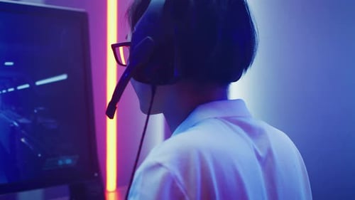 Gamer Playing Video Game with Headset On