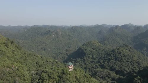 Panoramic tourist viewpoint tower on rugged mountain ridge, Vietnam