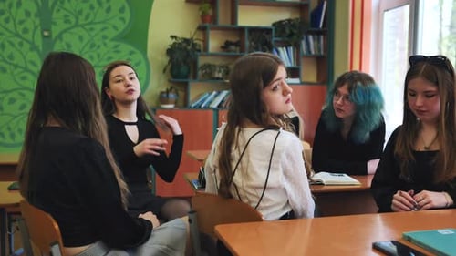 Five Young Women Talking in a Classroom