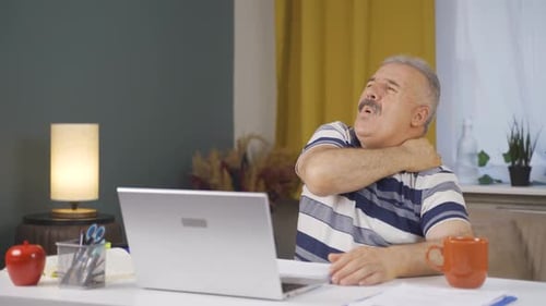 Home office worker old man has shoulder pain.