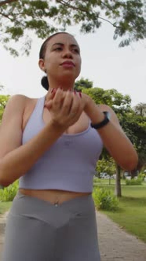 Fit Woman Doing Stretching Exercises in Park