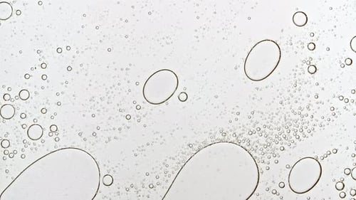 Abstract Bubbles Moving Against Light Background