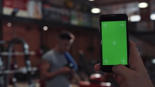 Close Up Hand Man Use Phone with Vertical Green Screen in in Sport Club Background Man Touch Approve