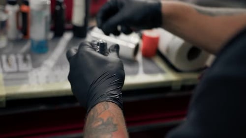 Gloved Hands Prepare Tattoo Equipment Close Up