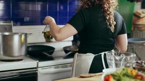 Cook Frying Eggplant in a Large Kitchen with an Array of A