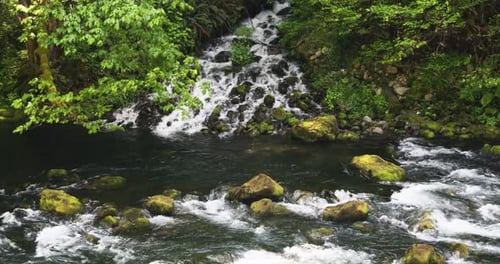 Water Flowing Into Mossy Rocks In The River. - static