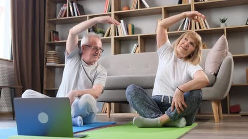 Senior Couple Doing Yoga Together at Home