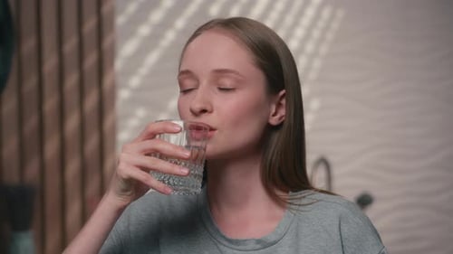 Healthy Woman Caucasian Happy Female Girl in Home Bathroom Smile Drink Glass Water Thirst Body Care