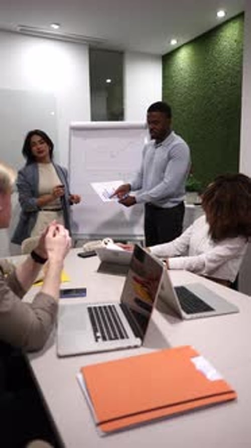 Business Professionals at a Conference Table Discussing Presentation