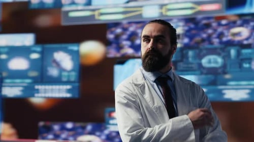 Medical Researcher Stands Before Glowing Scan Displays