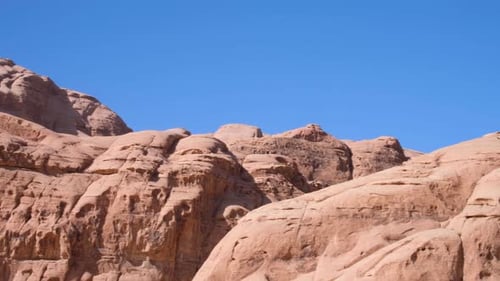 Red and rugged mountainous desert landscape of remote Wadi Rum wilderness in Jordan, Middle East