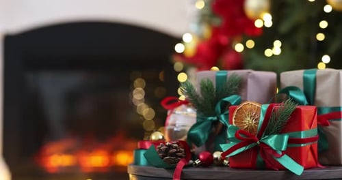 Christmas gifts by cozy fireplace with twinkling lights