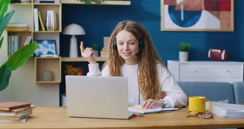 Customer Service Mobile Operator in Headset Having Conversation with Clients in Cozy Call Center
