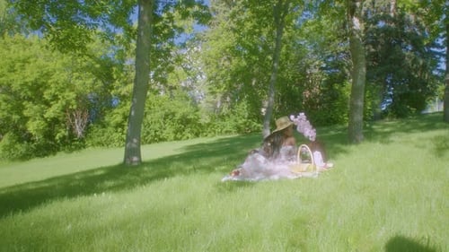 Black Woman watching waiting in park picnic blanket