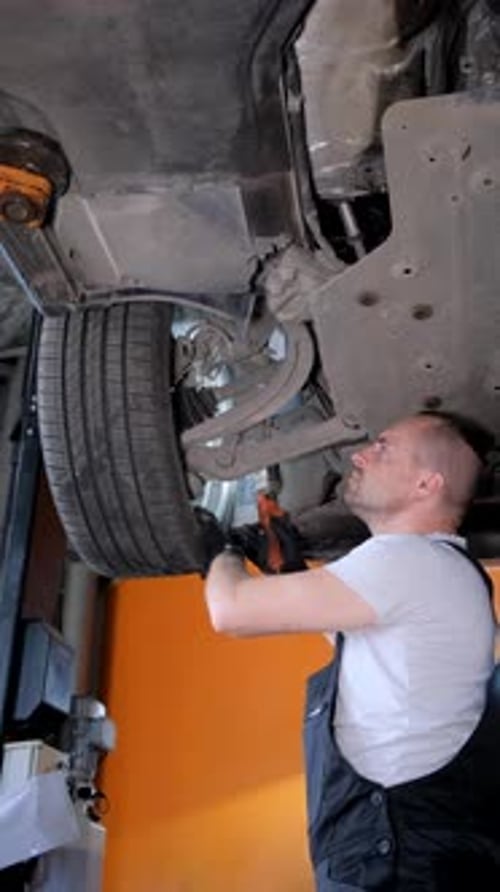 Car Mechanic Working in Auto Repair Shop