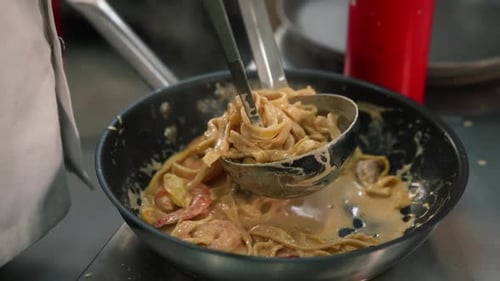 Pasta With Shrimp Being Stirred in Pan
