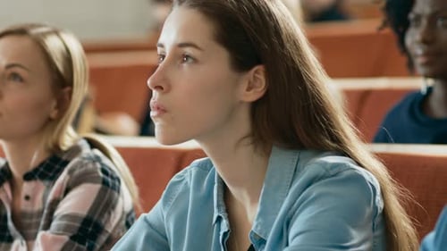 Students intently listening in a university lecture hall