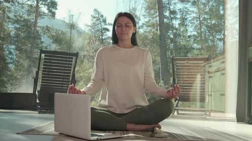 Woman Practicing Online Yoga in Front of Laptop in Mountain House