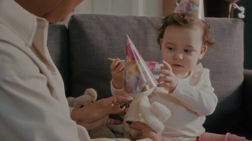 Adult Attends Birthday Party With Child and Toys