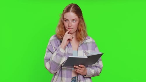 Young Woman Taking Notes and Writing on Green Screen