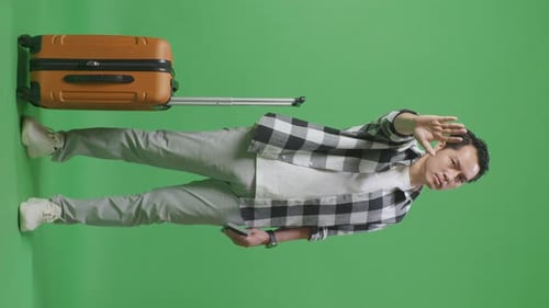 Male Traveler With Luggage And Passport Disapproving With No Hand Sign In The Green Screen