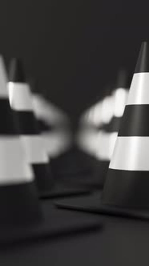 Front View Grid of Traffic Cones in White and Black on a Black Background for Road Safety and
