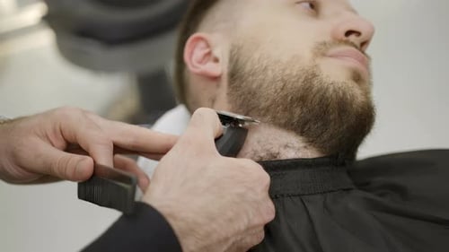 Man Having Beard Trimmed at Barber Shop