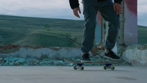 Skateboarder Practices Tricks in Urban Ruin