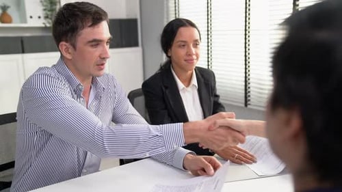 Business People Shaking Hands in Modern Office