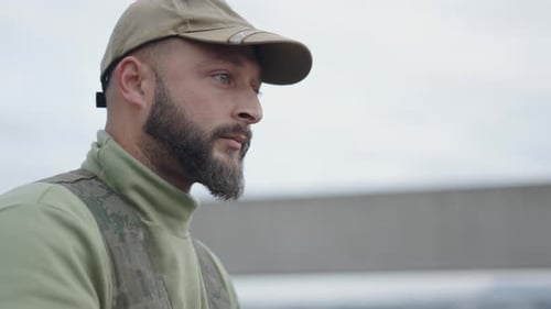 Man with Beard Wearing Baseball Cap and Camouflage